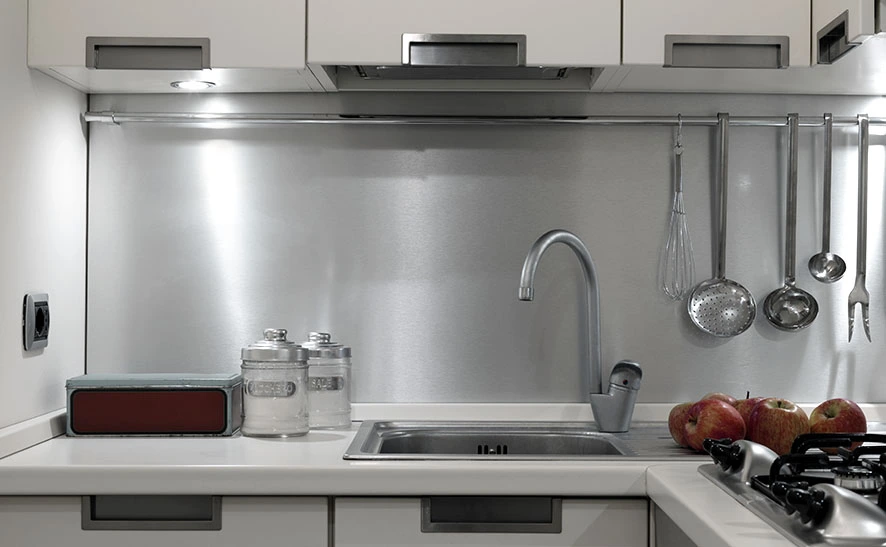 stainless steel drop-in kitchen sink with a quartz countertop